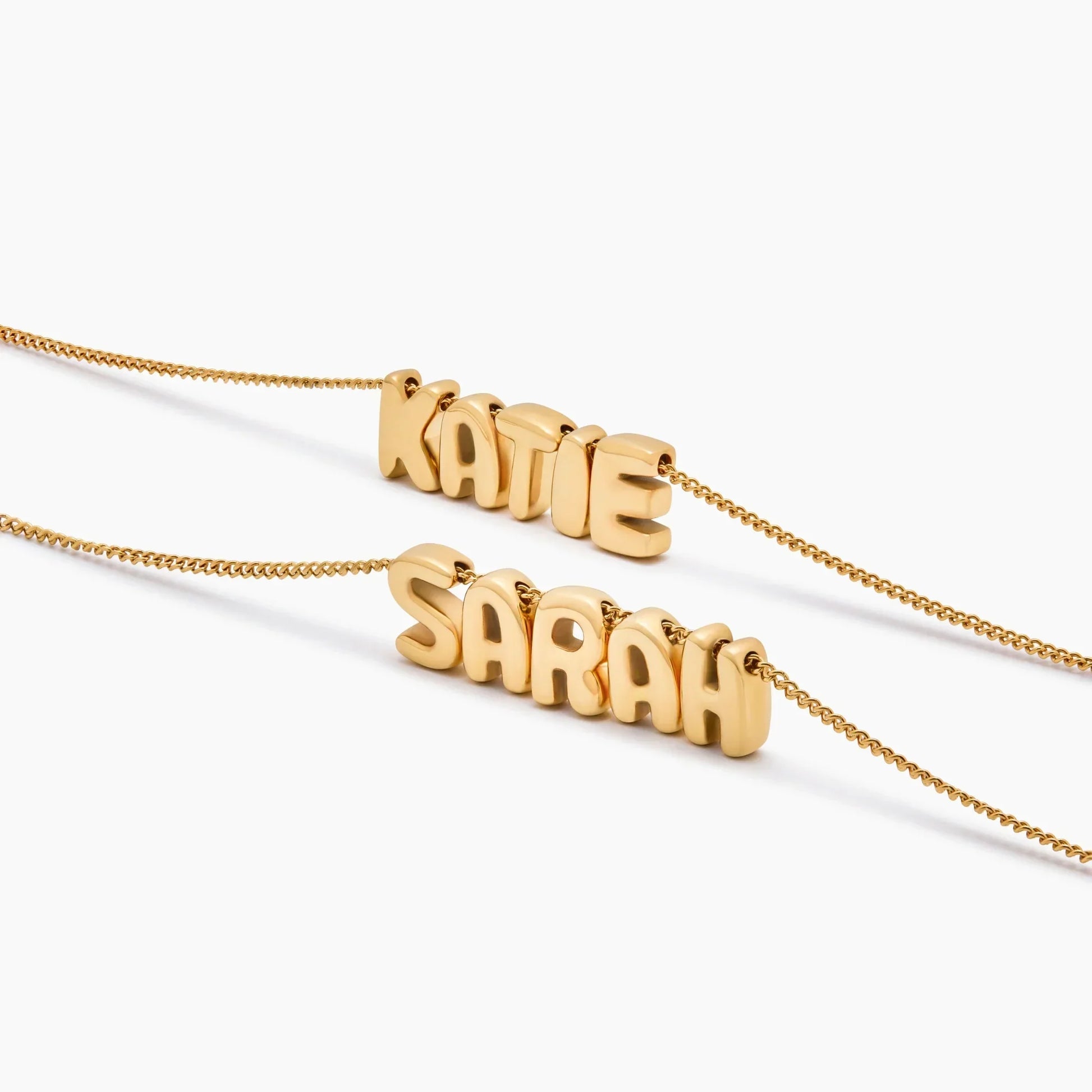 Gold bubble name necklace worn on model — Olivia Jewelry